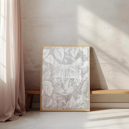 Framed artwork of a cat on a wall in a bright room with sunlight streaming through a window.