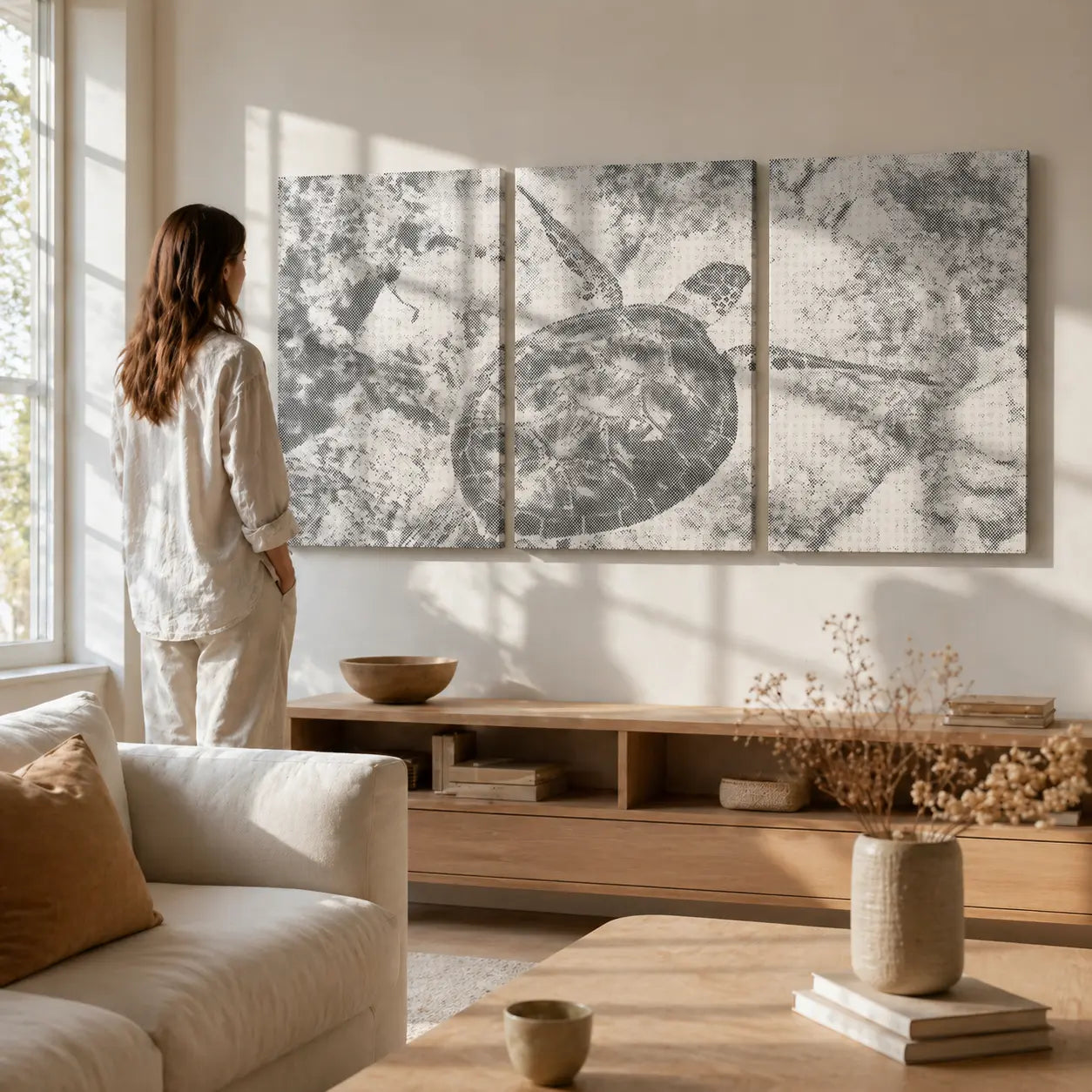Woman standing in a living room looking at a large turtle artwork on the wall. Sea Turtle Ocean | Multi Panel Dot Painting