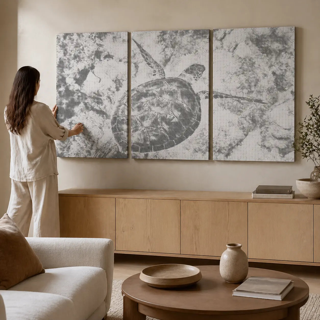 Woman arranging abstract wall art in a living room. Sea Turtle Ocean | Multi Panel Dot Painting